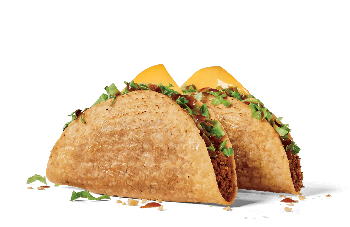 Two crispy shell tacos filled with seasoned ground beef, shredded lettuce, and cheddar cheese, set against a transparent background.