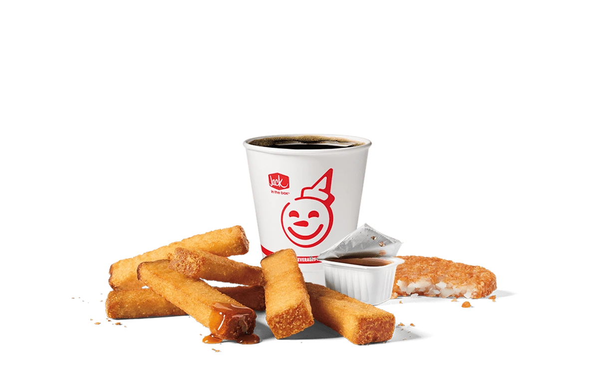 Image of a 6-piece Classic French Toast Sticks combo from Jack in the Box, featuring golden-brown French toast sticks accompanied by syrup for dipping and a cup of hot coffee, displayed against a transparent background with the iconic Jack in the Box logo.