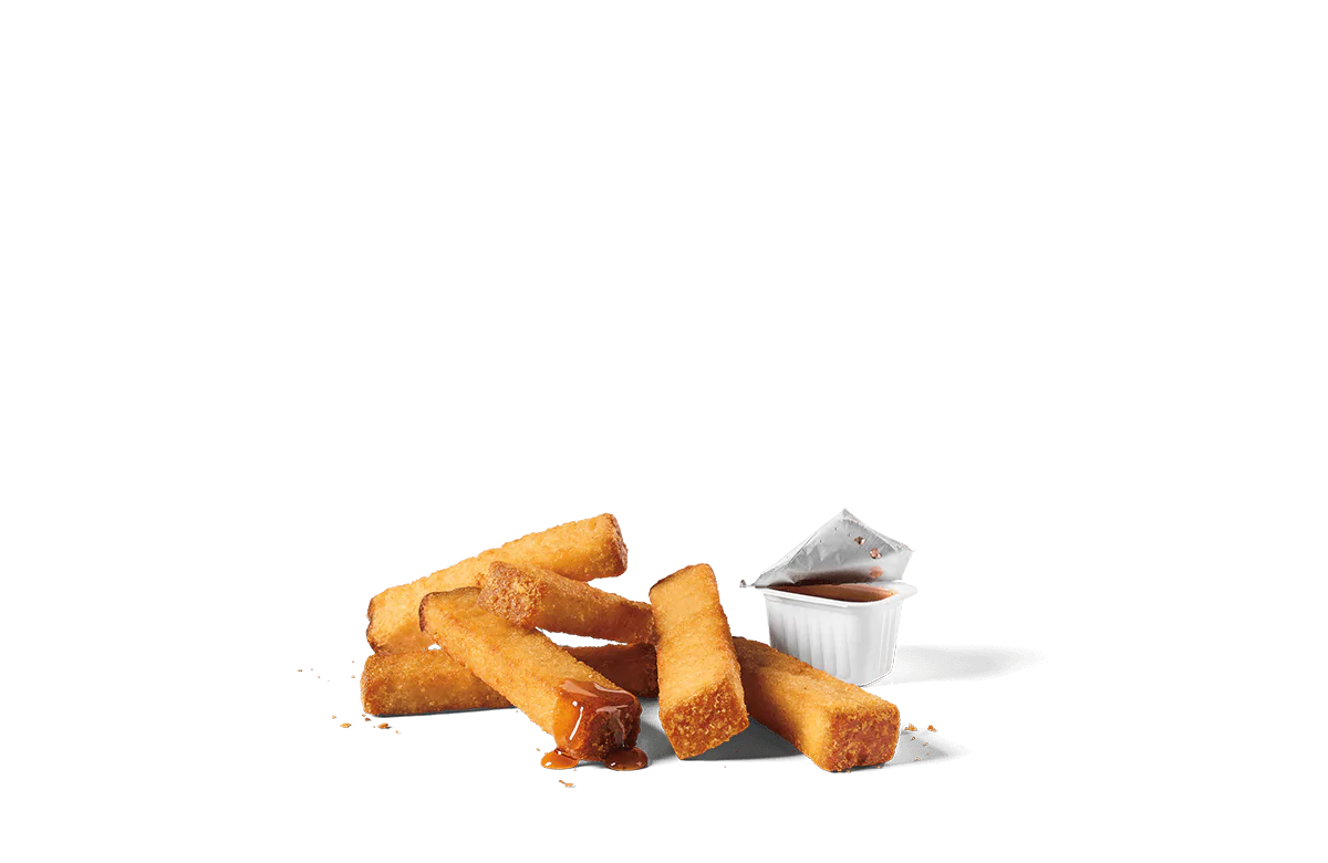 A serving of six golden, crispy French toast sticks accompanied by a container of dipping syrup, presented on transparent background.