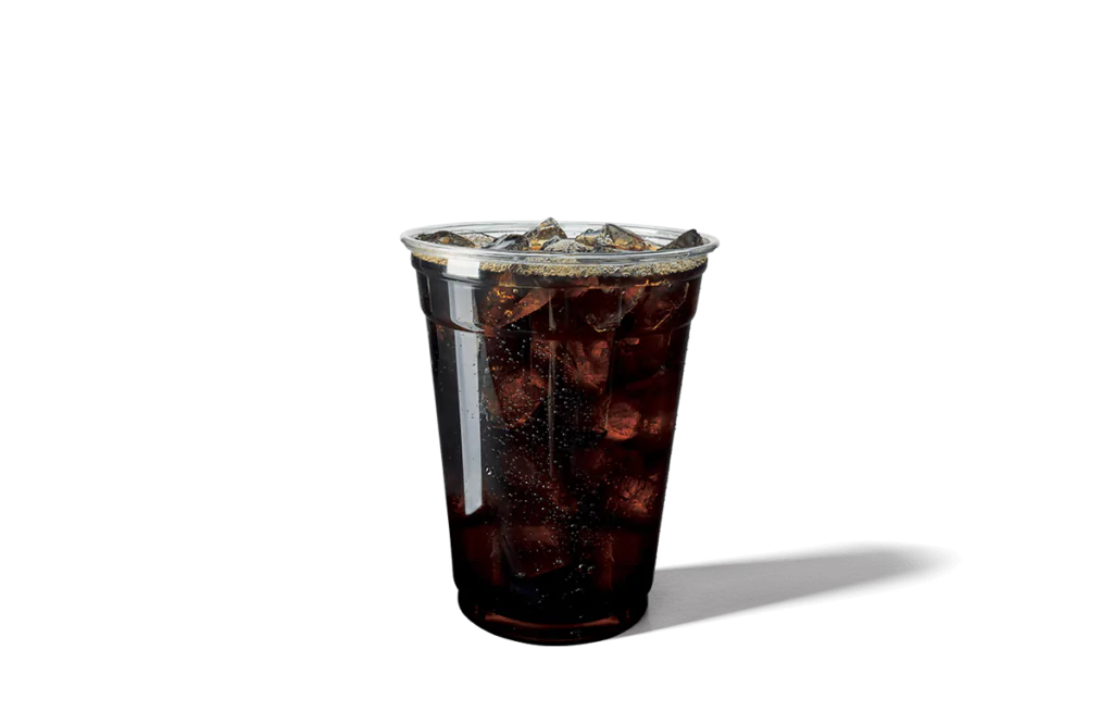 A transparent cup filled with refreshing black iced coffee, showcasing dark coffee with ice cubes floating inside. The cup is sealed with a clear plastic lid, and droplets of condensation form on the outer surface, emphasizing its chilled and invigorating appeal.