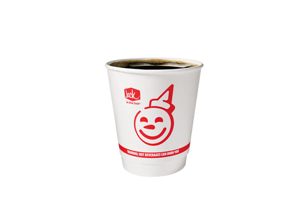 A white disposable cup filled with high mountain Arabica coffee, featuring the "Jack in the Box" logo and a smiling face design on the front. The cup has a visible brim of hot coffee, emphasizing its warmth and inviting nature. A warning label at the bottom reads, "Hot beverages can burn you," ensuring safety.