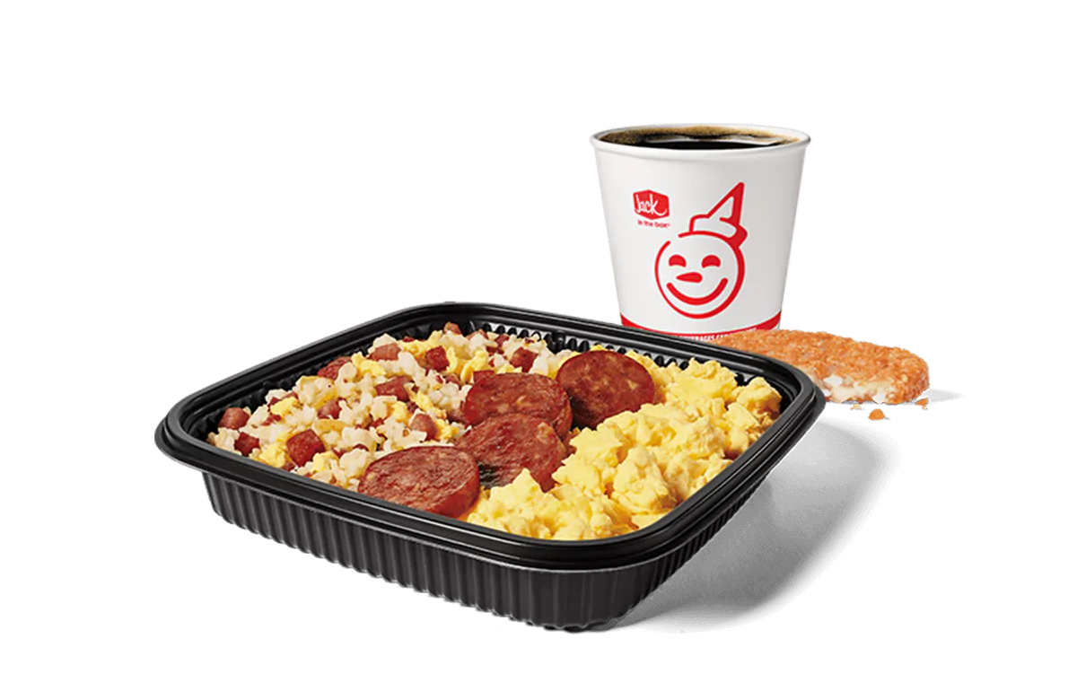 Image depicting a hearty breakfast platter from Jack in the Box, consisting of fried rice mixed with chunks of Portuguese sausage and scrambled eggs. The combo also includes a hash brown and a coffee cup adorned with the chain's iconic red smile logo. This meal is presented on a dark, sleek tray for a satisfying morning option.