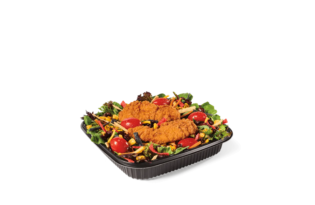 A fresh salad with crispy chicken tenders, featuring cherry tomatoes, mixed greens, black olives, shredded cheese, and a variety of colorful vegetables.