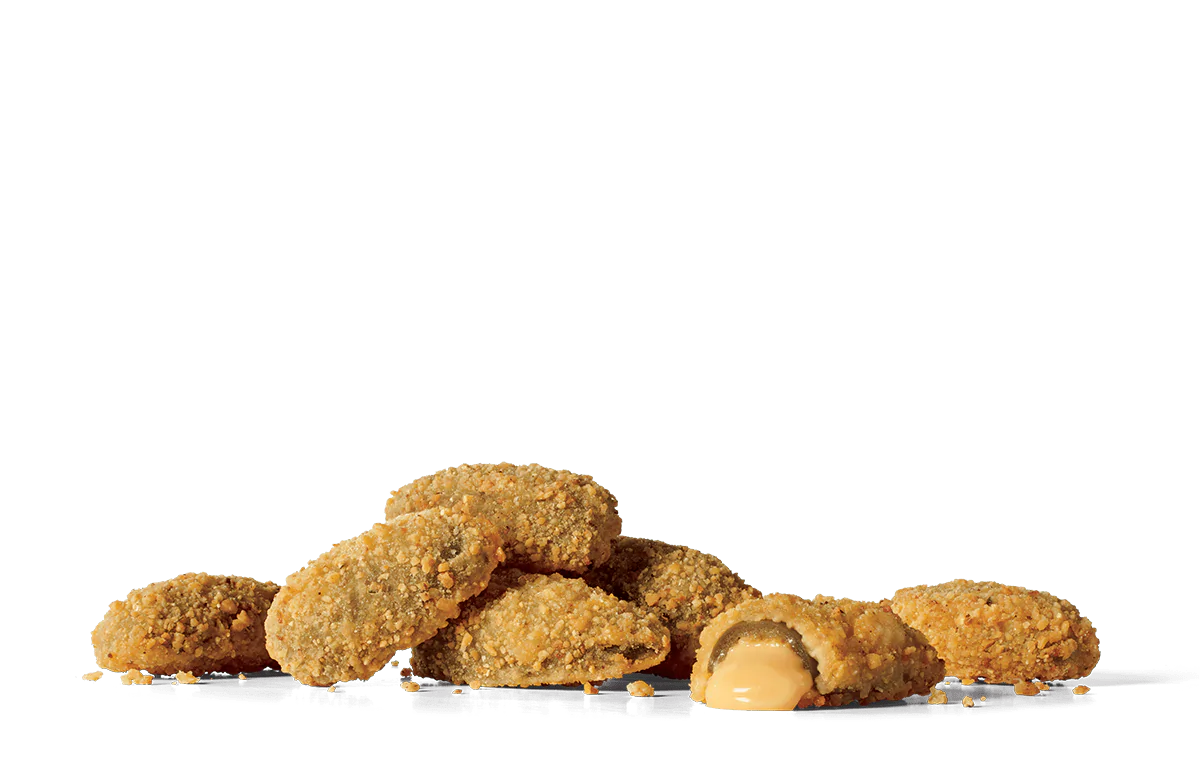 A pile of crispy breaded stuffed jalapeños on transparent background. One of the jalapeños is cut open, revealing a creamy cheese filling oozing out. The jalapeños are golden brown and coated with a crunchy breadcrumb mixture.