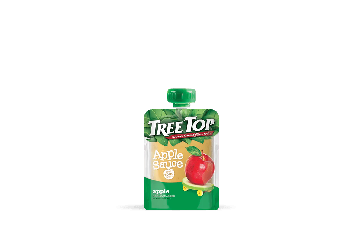 A Tree Top apple sauce pouch on transparent background. The pouch is prominently displayed, showing a bright red apple and green leaves on the packaging. The label reads 'Tree Top Apple Sauce, No Sugar Added, Grower Owned Since 1960, apple,' emphasizing the natural ingredients and heritage of the brand.