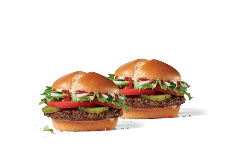 Two veggie burgers with glossy buns, loaded with a thick beef patty, crisp lettuce, fresh tomato slices, creamy mayonnaise, and bright green avocado on a transparent background.
