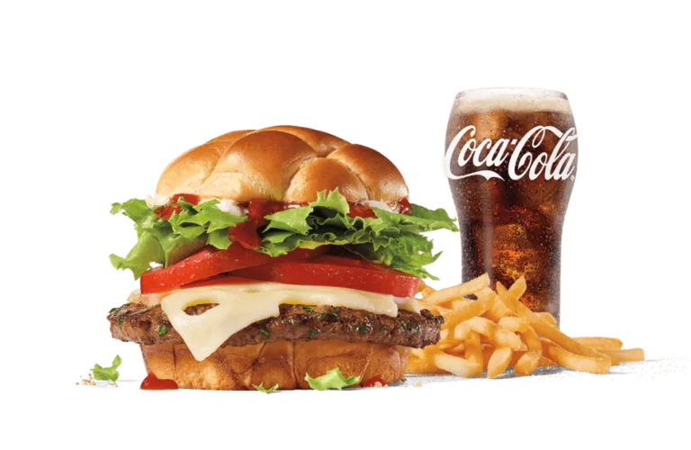 The Classic Buttery Jack® Combo includes a beef burger with a buttery bun, topped with Swiss cheese, fresh lettuce, and red ripe tomatoes, accompanied by crispy French fries and a glass of Coca-Cola.