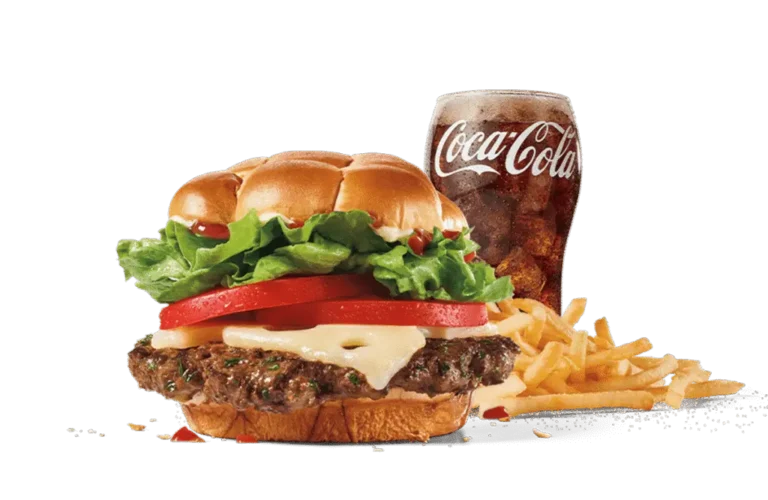 The Classic Buttery Smashed Jack™ Combo features a juicy burger topped with lettuce, tomato, and Swiss cheese on a buttery bun, served with crispy fries and a Coca-Cola, highlighted against a muted background.
