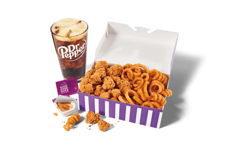 An appetizing display of classic popcorn chicken and curly fries in a large white and purple striped box, paired with a foamy glass of Dr Pepper and a sauce packet, presented on transparent background for a hearty meal.
