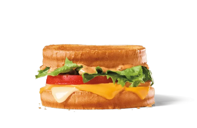 A jumbo sourdough grilled cheese sandwich featuring layers of melted cheese, fresh lettuce, a slice of tomato, and a creamy sauce, served on toasted sourdough bread.