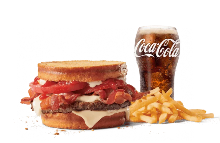 The Sourdough Jack® Combo features a burger with a beef patty, bacon, and tomato, sandwiched between toasted sourdough bread, accompanied by crispy fries and a glass of Coca-Cola on transparent backdrop.