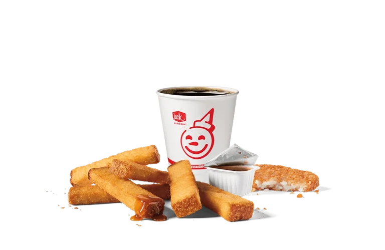 Image of a 6-piece Classic French Toast Sticks combo from Jack in the Box, featuring golden-brown French toast sticks accompanied by syrup for dipping and a cup of hot coffee, displayed against a transparent background with the iconic Jack in the Box logo.