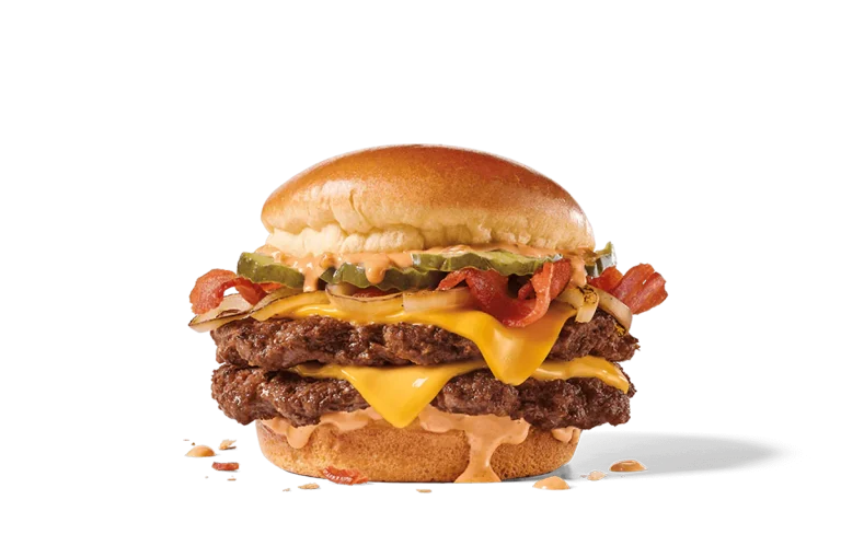 Bacon Double Smashed Jack burger with two beef patties, melted cheddar cheese, crispy bacon, pickles, onions, and creamy sauce, all on a toasted bun.