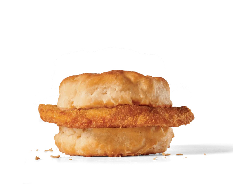 Image of a Chicken Biscuit featuring a crispy chicken fillet with a golden breading, placed within a soft, lightly browned biscuit, with a few crumbs visible around the sandwich, highlighting the crunchiness of the chicken.