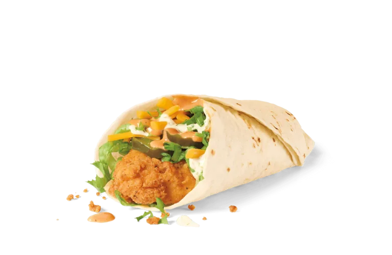 A freshly made wrap featuring a crispy breaded chicken patty, surrounded by shredded lettuce, diced yellow and green bell peppers, and drizzled with a creamy sauce, all encased in a soft flour tortilla. The wrap is partially open, showing its savory contents, with crumbs scattered around on transparent background.