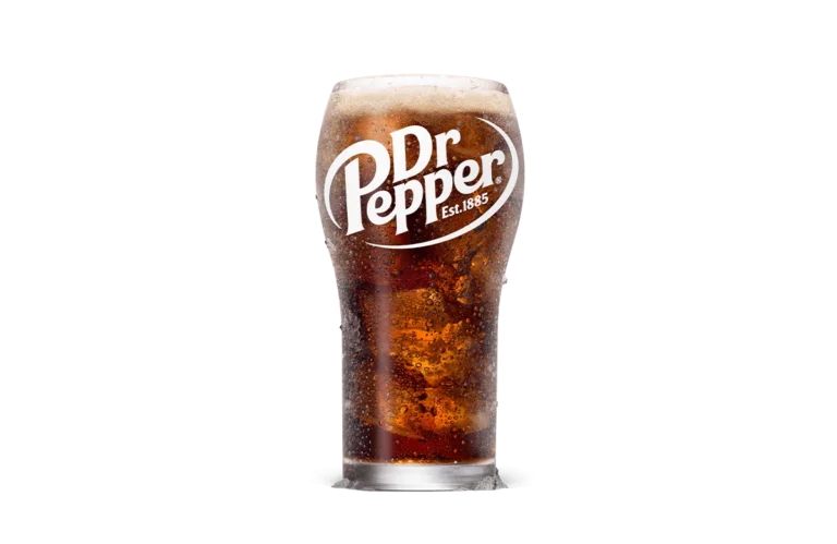 A tall glass of Dr Pepper soda, effervescent and deep amber in color, with the distinctive Dr Pepper logo emblazoned in white on the glass. The glass is filled to the brim, showcasing the drink's bubbly texture against a simple, transparent background.