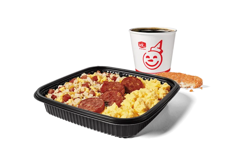 Image depicting a hearty breakfast platter from Jack in the Box, consisting of fried rice mixed with chunks of Portuguese sausage and scrambled eggs. The combo also includes a hash brown and a coffee cup adorned with the chain's iconic red smile logo. This meal is presented on a dark, sleek tray for a satisfying morning option.