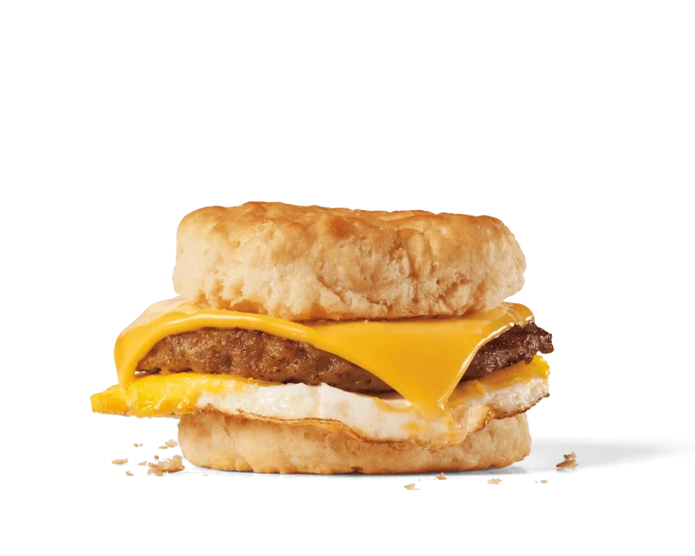 Image of a sausage, egg, and cheese biscuit, featuring a savory sausage patty topped with a fried egg and a slice of melted American cheese, sandwiched between a soft, flaky biscuit, forming a hearty breakfast sandwich.